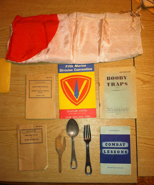 Japanese flag, field manuals, 1951 reunion booklet, and field utensils